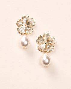 Bring a soft, feminine touch to your wedding day look with our Hayden Pearl Earrings. Each detailed metal flower is accented with an off white pearl drop that dangles effortlessly. Off white pearls Measures 1" x 1.5" long Hypoallergenic, lead-free & nickel-free Style #4456 Flower Shaped Metal Jewelry For Weddings, Delicate Pearl Drop Earrings With Flower Shape, Delicate Pearl Drop Earrings In Flower Shape, Pearl White Flower Earrings, White Flower-shaped Pearl Earrings For Formal Events, White Pearl Earrings In Flower Shape For Formal Events, Delicate Flower Shape Pearl Drop Earrings, White Floral Pearl Earrings For Formal Occasions, White Floral Pearl Earrings For Formal Events