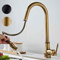 a person is using a kitchen sink faucet