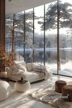 a living room filled with furniture next to a window covered in frosty trees and snow