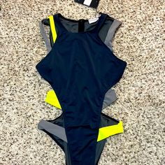 Iconswim Dark Grey Cut Out Swimsuit. Size Small. New With Tags. Grey Swimsuit Featuring Green And Grey Strap Detailing. Runs True To Size Double-Lined Cheeky Coverage Bottoms Swim Fabric: 86% Nylon, 14% Spandex Model Is Wearing A Small Nike One Piece Swimsuit, Grey Swimsuit, Halter Neck Swimsuit, Bandeau One Piece Swimsuit, Future Clothes, Plunging One Piece Swimsuit, Floral One Piece Swimsuit, Halter One Piece Swimsuit, Cut Out Swimsuits