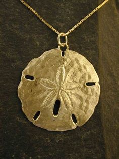 This Atlantic Sand Dollar pendant is 14K Gold. The included chain is a 18" 14K Gold. Other length available at  higher prices. This Atlantic Sand Dollar pendant measures 1 1/2" in diameter. I hand cast all my pieces using the lost wax casting method. Please ask your needs. You may call me with questions, often I am out so please use my machine. 831-476-3176. Satisfaction Guaranteed!This item ships USPS Registered Insured.This Sand Dollar pendant take me 2 to 3 weeks to make.I send items USPS Fir Gold Medallion Jewelry Hand Cast, Gold Medallion Hand Cast Jewelry, Hand Cast Sterling Silver Gold Jewelry, Hand Cast Gold Sterling Silver Jewelry, Celtic Knot Earrings, Sand Dollar Pendant, Sea Turtle Necklace, Tahitian Black Pearls, Polymer Crafts