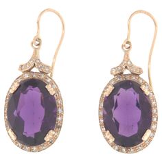 These elegant 14-karat yellow gold earrings are a perfect combination of luxury and sophistication, featuring stunning amethysts and diamonds. With their sophisticated design and use of precious materials, these earrings are ideal for adding a touch of elegance and color to any outfit, making them perfect for special occasions or as a distinctive piece for everyday wear. Each earring is meticulously crafted from 14-karat yellow gold, providing a solid and lustrous base for the set gemstones. The centerpiece of the earrings is a large oval amethyst, known for its deep purple color that ranges from light lavender to intense violet. Amethyst is a precious stone valued not only for its beauty but also for its calming and spiritual properties, making these earrings not only aesthetically pleasi Earring Video, Yellow Gold Drop Earrings, Emerald Earrings Drop, Earrings For Sale, Deep Purple Color, Light Lavender, Yellow Gold Earrings, Precious Jewels, Outfit Making