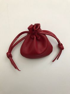 "This drawstring pouch bag is made with the finest soft and supple leather. Hand picked by me to ensure you are getting the very best. When you hold this little gem in your hand you will know what I mean.  Mini pouch size overall approx 3\" H X 3\" So many uses...wedding rings, crystals, gems, your lucky little charms? Color - RedPlease note this red in photo is a bit muted. It is a beautiful red Back to shop - http://www.etsy.com/shop/shirlbcreationstoo Read Customer Reviews from Shirlbcreationstoo customers here: http://www.etsy.com/people/oneredindian/feedback Made in the USA" Crystals Gems, Pouch Bags, Mini Pouch, Sack Bag, Coin Holder, Mini Pouches, Drawstring Pouch, Coin Purses, Purse Pouch