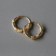 Delicate minimal gold plated sterling silver jewelry. Our products are made with 925 sterling silver and are hypoallergenic and nickel free! ★ This listing is for a PAIR of hoops.  ★ Hoop dimensions 14mm outer diameter, 12mm inner diameter  1.2mm thickness ★ Material 925 sterling silver  18k gold plating Your earrings will come in a cute gift box! We will ship them out asap, shipping is fixed price for as many items as you want. Gold Bali, Gold Minimalist Jewelry, Minimal Gold, Bali Earrings, Hoops Gold, Cute Gift Boxes, Fun Earrings, Jewelry Earrings Hoops, Gold Gold