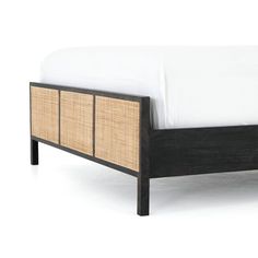 a bed with wicker drawers and white sheets on it's headboard, against a white background