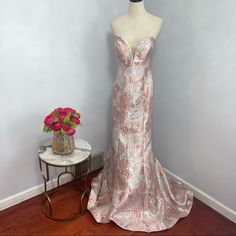 New With Tag Camilla La Vie Gown Color: Pink And Grey/ Silver Size: 10 Approx Measurements Laying Flat Armpit To Armpit: 18” Waist: 15 1/2” Front Length (From Armpit To Hem): 56 1/2” Back Length (From Armpit To Hem With Train): 62” Textured Fabric Floral Pattern Strapless Mermaid Style Jacquard Note: This Was In A Store. Had Been Tried On. May Show Some Signs Of That. Please Check The Images Before Purchasing. And Don’t Hesitate To Ask If You Have Any Questions. P3-22 5-22 1 B-8 Glamorous Brocade Dresses For Wedding, Silver Strapless Gown For Prom Season, Glamorous Brocade Wedding Dresses, Silver Strapless Prom Gown, Silver Strapless Gown For Gala, Metallic Floor-length Wedding Gown, Fitted Pink Floral Applique Dress, Strapless Pink Mermaid Dress, Silver Fitted Strapless Gown