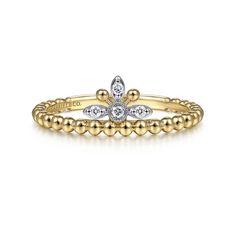 a yellow gold and white diamond flower ring