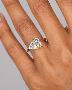 a woman's hand with a diamond ring on it