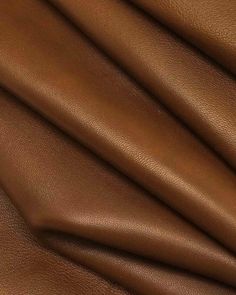 a close up shot of a brown leather textured material that is very soft and smooth