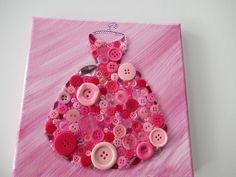 a pink and white painting with buttons on it's side, in the shape of a dress