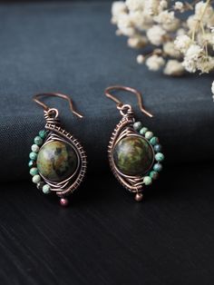 "These wonderful African turquoise earrings wire wrapped in raw copper were born out of desire to create something both elegant and inspired by woodland folktales. Made with fun and colorful faceted tiny 2 mm real turquoise beads (Turquoise is December Birthstone) and focal 12 mm African turquoise bead (form of Jasper). These copper earrings would make a wonderful jewelry gift for her. Perfectly suited for copper anniversary - gift for someone that feels enchanted by the legends of the magical w Artisan Copper Wire Drop Earrings, Bohemian Green Earrings With Copper Wire, Green Bohemian Earrings With Copper Wire, Green Bohemian Copper Wire Earrings, Bohemian Wire Wrapped Copper Earrings, Artisan Wire Wrapped Copper Earrings, Bohemian Hand Wrapped Copper Wire Earrings, Artisan Copper Wire Wrapped Earrings, Bohemian Hand Wrapped Copper Earrings