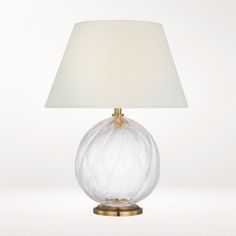 a glass table lamp with a white shade on it's base and a gold metal base