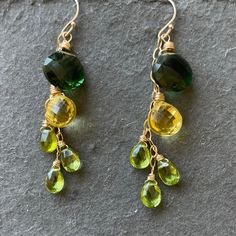 These beautiful laser faceteted quartz and peridots are wired with goldfilled wire on gold filled earwires. Shown are 14k gold filled French ball earwires. If shopping directly from shirzay.com there is a leverback upgrade available. The convex cut on the back of the larger stones is what makes these stones so sparkly. Length is apprx. 2.25”. Your earrings will arrive beautifully giftboxed. Chip Jewelry, Orange Gem, Dangle Earrings Silver, Colorful Jewelry, Lemon Lime, Gem Stone, Earrings Silver, Green Orange, Diy Jewelry