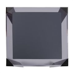 a silver and black square shaped object on a white background