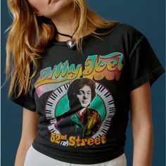 a woman wearing a t - shirt with an image of elvis presley on it