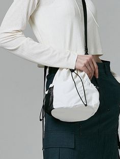 This is a casual and comfortable mini bucket bag that is made out of high quality polyester and nylon 100% fabric. With design detail of detachable cross strap and logo print on the back, it gives a trendy and casual mood.- Matte texture of nylon fabric- 3M elastic string and logo print on the back - Detachable cross strap White Crossbody Bucket Bag For On-the-go, Trendy White Shoulder Bag For Outdoor, White Bucket Shoulder Bag With Mobile Phone Pocket, Casual Bucket Bag With Mobile Phone Holder, White Bucket Shoulder Bag With Phone Pocket, White Shoulder Bucket Bag With Mobile Phone Pocket, White Shoulder Bucket Bag With Phone Bag, White Mobile Phone Bucket Shoulder Bag, Functional Bucket Bag For On-the-go