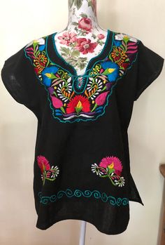 Mexican Embroider Women's Blouse/Tunic. Refer to photos or message me for questions. Length: approx. 25 1/2" Width: approx. 23" Black Tunic Blouse For Vacation, Black Tunic Blouse For Beach, Multicolor Bohemian Crew Neck Blouse, Multicolor Bohemian Blouse With Crew Neck, Bohemian Multicolor Crew Neck Blouse, Folk Style Multicolor Vacation Tops, Traditional Black Crew Neck Top, Bohemian Crew Neck Blouse For Vacation, Traditional Short Sleeve Tunic With Floral Embroidery