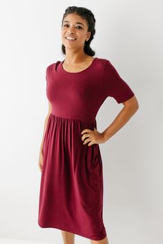 Your everyday dress is here, designed with you in mind! The 'Annie' is a slimming midi dress with a softly gathered waist for a modest and feminine fit now in a stunning burgundy shade. Made from a buttery-soft bamboo fabric, and functional pockets, you won't have to trade comfort for style. Ready to wear as is or add a feminine neck scarf or duster vest if you're feeling fancy! 50% Bamboo 42% Modal 8% Lycra Machine Wash Cold Hang to Dry Unlined Bump/Maternity Friendly! FINAL SALE: NOT ELIGIBLE Modest Fitted Ruched Dress, Daywear Midi Dress With Gathered Waist, Daywear Midi Dress With Pleated Waist, Solid Color Midi Dress With Pleated Waist For Daywear, Solid Midi Dress With Pleated Waist For Daywear, Modest Short Sleeve Solid Color Dress, Fitted Midi Dress With Elastic Waistband For Daywear, Casual Solid Midi Dress With Gathered Waist, Short Sleeve Midi Dress With Fitted Waist For Daywear