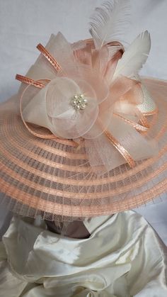 Big brim Peach and cream beautiful elegant good for all occasions. Derby ready Elegant Beige Cloche Hat For Beach, Elegant Beige Cloche Hat For The Beach, Elegant Pink Sun Hat For Summer, Chic Beige Mini Hat With Curved Brim, Elegant Pink Summer Sun Hat, Elegant Adjustable Cream Sun Hat, Chic Cream Boater Hat For Garden Party, Elegant Beige Fedora Straw Hat, Elegant Cream Boater Hat With Flat Brim