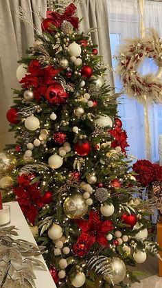 a christmas tree decorated with red and silver ornaments