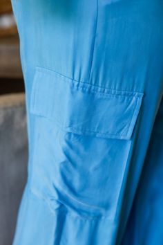 Get ready to strut your style this spring with our Laura cargo pants! With a gorgeous electric blue shade, these pants will add a pop of color to any outfit. Plus, their cargo design provides plenty of pockets for all your essentials. Step out in style and functionality with Laura! 100% Rayon Color: Flat Blue with Shimmer Button/ Zipper Closure Multi Pockets Half Elastic Waist BAND Light Weight Utility Cargo Style Straight Leg Belt Loops True to size Model is wearing a size Small. She is 5'6". 1 Casual Blue Pants With Flap Pockets, Blue Relaxed Fit Cargo Pants With Pockets, Blue Relaxed Fit Utility Pants, Blue Relaxed Fit Cargo Pants, Blue Relaxed Fit Cargo Pants For Work, Blue Relaxed Fit Cargo Pants With Patch Pockets, Blue Tapered Leg Cargo Pants, Blue Tapered Leg Cargo Pants With Pockets, Blue Relaxed Fit Utility Bottoms