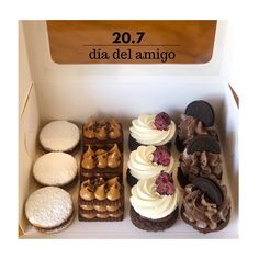 a box filled with lots of different types of cakes and pastries on top of each other