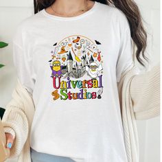 a woman wearing a white tshirt with the words universal studios on it