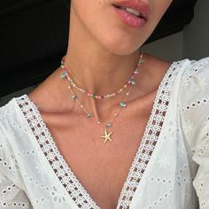 Add a touch of boho chic elegance to your summer look with this stunning handmade layering necklace. The delicate golden starfish pendant is perfectly paired with colorful beads and turquoise details, creating a unique and charming accessory. Made with care, this necklace is ideal for those who love a casual but refined style. Perfect to wear on the beach, for an evening out or as a complement to a light dress, this necklace is the detail that makes the difference. Give yourself or a loved one a Beach Star Charm Necklace, Turquoise Necklaces With Starfish Charm For Beach, Turquoise Necklace With Starfish Charm For Beach, Beach Turquoise Necklace With Starfish Charm, Star Charm Necklaces For Beach, Summer Turquoise Necklace With Colorful Beads, Star Charm Necklace For Beach, Dainty Starfish Necklace For Beach, Bohemian Charm Necklaces With Starfish Charm For Beach