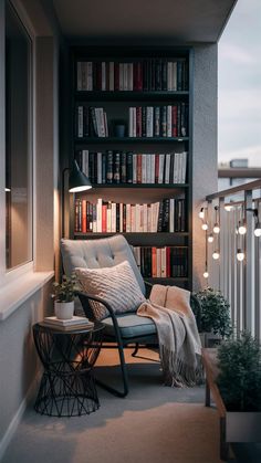 a chair sitting on top of a balcony next to a book shelf filled with books