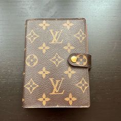 an old louis vuitton notebook on a table