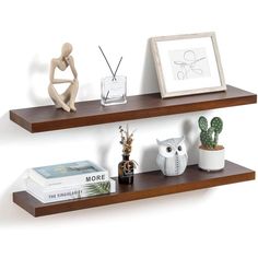 two wooden shelves with books, vases and an owl figurine on them