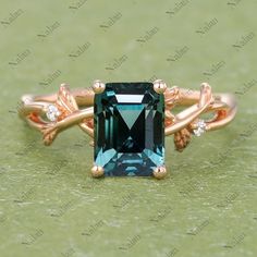 a ring with an emerald colored stone in the center