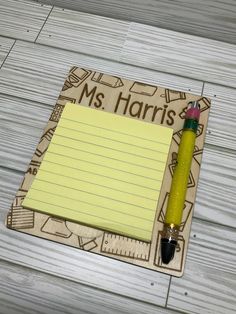 a note pad with a pen and pencil on it next to a ruler that says ms horris