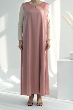 This essential Dunia Slip Dress is crafted in a maxi length and features a sleeveless design. It is perfect to wear under or with main dress of the corresponding color. With its classic look and feel, this dress will be sure to have you looking and feeling comfy. Easy to wear alone or as a layering piece, this dress will certainly be a staple in your modest clothing collection. Add a touch of elegance to your wardrobe with the Pink Duniia slip dress. Crafted from luxurious satin fabric, this max Slip Dress Maxi, Modest Activewear, Full Coverage Swimsuit, Abaya Dress, Modest Clothing, Maxi Slip Dress, Dress Maxi, British Indian, Active Wear Tops