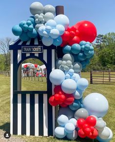 a train ticket booth is decorated with balloons