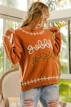 Get your gobble on with the Gobble Gobble Sweater! This playful sweater will have you looking festive and feeling cozy. Perfect for Thanksgiving or any chilly day, it's a must-have for those who love a good laugh. No serious turkeys allowed! Rompers Dressy, Yarn Sweater, Gobble Gobble, Jumpsuit Skirt, Skirt Leggings, Love A, Short Pants, Jacket Dress, Sweater Top