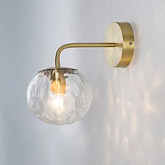 a light that is on the side of a wall with a glass ball hanging from it