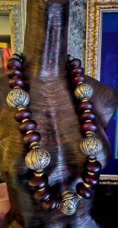 Rare and Scarce beads abound in this lightweight, 34" Moroccan Burgundy Resin and Tibetan Silver Fancy Repousse Tribal Statement Rope. Each bead is separated by a gold aurora borealis rhinestone rondelle. Iris Apfel Inspired. The back is finished with tribal silver tone stamped bi-cones, round black onyx, tribal spacers and ornate bi-cones. Fastens with a fancy hook and eye. Unisex styled. Great worn alone or as a layering piece. From KatKouture. Rocker Chic Accessories, Unique Pendant Necklace, Long Statement Necklace, Statement Bib Necklace, Cyberpunk Fashion, Elephant Head, Mermaid Necklace, Neck Piece, Statement Pendant