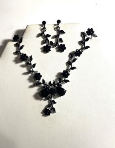 "Beautiful Black Crystal Rose Necklace & Earrings Set , Black Metal Flowers Jewelry Set  Beautiful Necklace is 15 1/2 \" and the black crystal drop is 2\" long. The earrings are almost 1 1/2 \" long. Black crystals are in the Roses and leaves and in the center of 2 Pear shaped black crystals and then leaves with black crystals and a black crystal Rose and the end. Earrings have a black crystal stud and a black crystal Rose flower and black crystal leaves. Please ask question as I do not accept r Black Sparkly Jewelry, Prom Jewelry Black Dress, Black Elegant Necklace, Black Bridal Jewelry, Black Homecoming Jewelry, Black Necklace And Earring Set, Black Rose Accessories, Black Prom Necklace, Black Jewellery Set