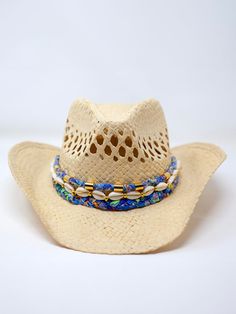 Our Coastal Cowgirl Straw Hat is perfect for a day at the beach or a summer festival. Adorned with a hand braided fabric and hand beaded cowrie shells – each cowgirl hat band is unique and one of a kind! Material: StrawSize: 4" deep, brim approx 3.5", approx 23" around Blue Western Straw Hat For Summer, Blue Brimmed Straw Hat For Rodeo, Western Blue Straw Hat For Summer, Blue Summer Hats For Country Events, Blue Western Straw Hat With Curved Brim, Western Style Blue Straw Hat For Summer, Blue Wide Brim Straw Hat For Rodeo, Blue Western Hat For Vacation, Western Blue Wide Brim Sun Hat