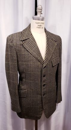 Beautiful houndstooth cloth two piece suit probably made in the 70's but exceptional quality. With the proper accessories it would be hard to tell this is not a true period piece, but the next best thing. Ready for the Dickens Faire or a period holiday party. Inside label reads: Mike Bain Inside pocket still has the Amalgamated Union Tag made in the USA the United States of America. Coat measures: Shoulders 18 1/2 inches, Chest 45 inches, sleeves 25 inches and length is 31 inches. Pants measure: Semi-formal Tweed Jacket With Houndstooth Pattern And Suit Collar, Black Houndstooth Tweed Jacket For Formal Occasions, Semi-formal Houndstooth Tweed Jacket With Suit Collar, Semi-formal Tweed Jacket With Houndstooth Pattern, Semi-formal Houndstooth Tweed Jacket, Fitted Black Tweed Jacket With Houndstooth Pattern, Fitted Vintage Outerwear With Houndstooth Pattern, Vintage Houndstooth Outerwear With Notch Lapel, Vintage Fitted Houndstooth Blazer