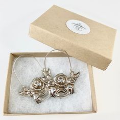 "These earrings are made from a vintage silver dish which had a beautiful embossed around the edge of flowers and other art nouveau motifs. I followed the line of the pattern into a point, drilled it and attached a sterling silver ear wire which is attached to either side of the charm. One side is hooked and unloops from the other side for you to insert the ear wire, and then clip it back up. They are very lightweight but are so eye catching. Measurements: Charm Length: 53 mm / 2.08\" Charm Widt Antique Silver Engraved Earrings Gift, Antique Silver Engraved Earrings For Gift, Vintage Silver Hoop Earrings For Wedding, Vintage Small Hoop Jewelry Gift, Vintage Nickel-free Hoop Earrings For Gift, Vintage Metal Hoop Earrings As Gift, Vintage Silver Hoop Earrings With Ear Wire, Vintage Sterling Silver Hoop Earrings For Gift, Vintage Sterling Silver Hoop Earrings As Gift