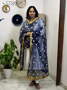 "Navy Blue Women, Ethnic Wrap, Designer Wrap, Party Wear Stoles, Lehenga Dressup Stoles, Bridal Dupatta, Women Scarfs Stoles, Elegent Stoles, Evening Scarves, Occasion Dress Dupatta.  Embroidery sequin Work in Floral Design Work Net Dupatta. The Dupatta has lovely sequin embroidery all over with beautiful border on all the four sides. This stunning Indian Embroidered Scarves Dupatta / Stole has perfect for wedding occasion, evening, cocktail, Christmas, feast of year-end. Select matching dupatta for your lengha skirt, for Punjabi suits etc. Material: Net Fabric Product: Net Dupatta Color: Navy blue Embroidery with Gold sequin.  Condition: New Care: Dry Clean Only Code: st899 Dimension: Length: approx. 96\" (2.4 Meter) Width: approx. 42\" Perfect for gifting purpose for festive season and o Blue Indian Wedding, Lehenga Embroidery, Wedding Dupatta, Evening Scarf, Bridal Dupatta, Robes D'occasion, Punjabi Dress, Embroidered Scarf, Lehenga Skirt