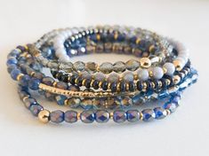 "Monochromatic bracelet stacks, made up of high-quality czech glass beads and semi-precious gemstones! This blue stack contains a semi-precious sodalite bracelet. Purchase an individual bracelet, or choose \"Entire Stack\" from the drop-down to receive one of each. The bracelets have been designed to look great on their own, and they stack beautifully with any of the bracelets in our shop!  All the bracelets in the stack are a dainty 4mm size-- the faceted glass beads hit the light and create sp Natural Gemstone Jewelry Stretch Bracelets, Stacked Crystal Bracelets, Blue Bracelet Stack, How To Make Stretchy Beaded Bracelets, Stretch Beaded Bracelets Diy, Monochromatic Blue, Sodalite Bracelet, Sundance Jewelry, Bracelet Stacks