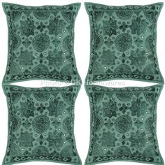 four green decorative pillows with beadings on the sides and one in the middle