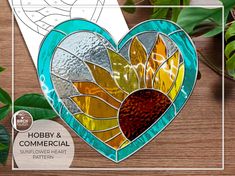 a stained glass heart sitting on top of a wooden table