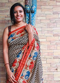 This Chanderi with beautiful kalamkari border is finely crafted by the blend of cotton and silk. The texture of this saree will guaranteed give you an elegant and classy look. Shop it to experience the beauty of original Chanderi Saree.   It has attached unstitched blouse material. The color of blouse will be the same as shown in the last picture. The blouse worn in the image is just for styling purpose.                                           Details:                                                                           Fabric: Hand dyed Chanderi and hand block printed saree (Cotton silk) Blouse piece: Base color printed (dotted) blouse piece. Length of Saree: 6 meters Length of Blouse: 80cm Note: We provide all services for our buyers like fall, Pico and blouse stitching. It will t Pre-draped Tussar Silk Saree With Kalamkari Print, Multicolor Cotton Saree With Border, Red Cotton Silk Blouse Piece With Kalamkari Print, Red Cotton Silk Saree With Kalamkari Print, Slub Silk Pre-draped Saree With Kalamkari Print, Cotton Silk Pre-draped Saree With Kalamkari Print For Festivals, Festival Cotton Silk Pre-draped Saree With Kalamkari Print, Bohemian Cotton Silk Saree For Navratri, Cotton Silk Pre-draped Saree With Border