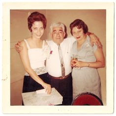 an older man and two women posing for a photo