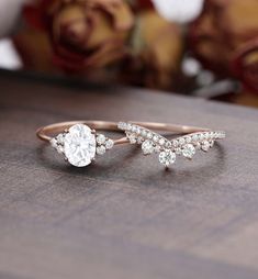 two wedding rings sitting on top of a wooden table