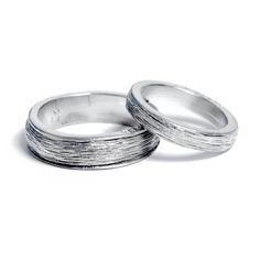 two silver rings sitting on top of each other